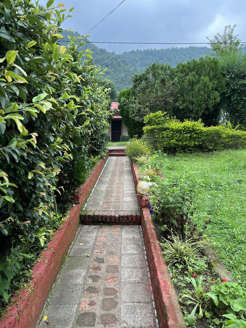 Brick garden path leading to a cottage